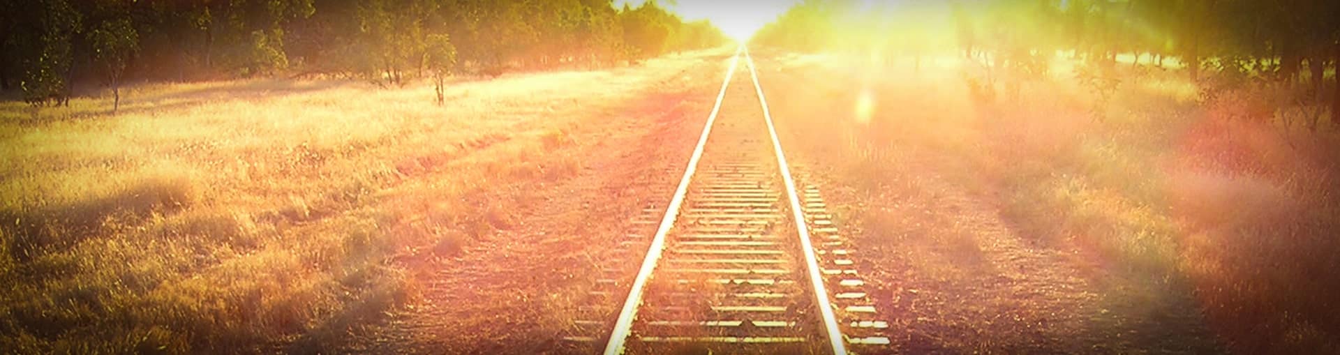 Railway line heading into the sun